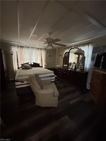Bedroom featuring dark wood-style floors and ceiling fan