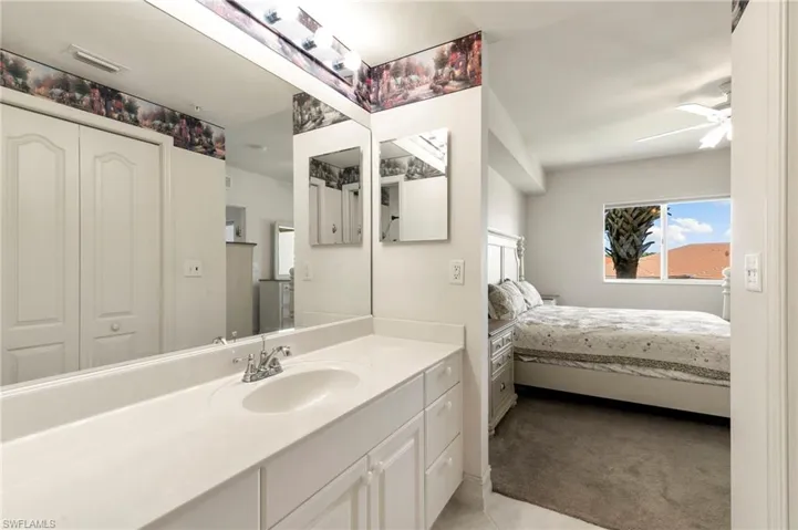 Ensuite bathroom with ceiling fan and vanity