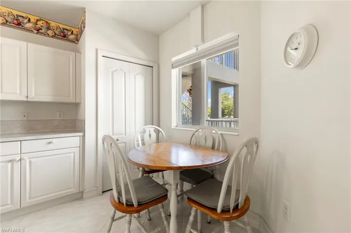 Dining space with light tile patterned floors