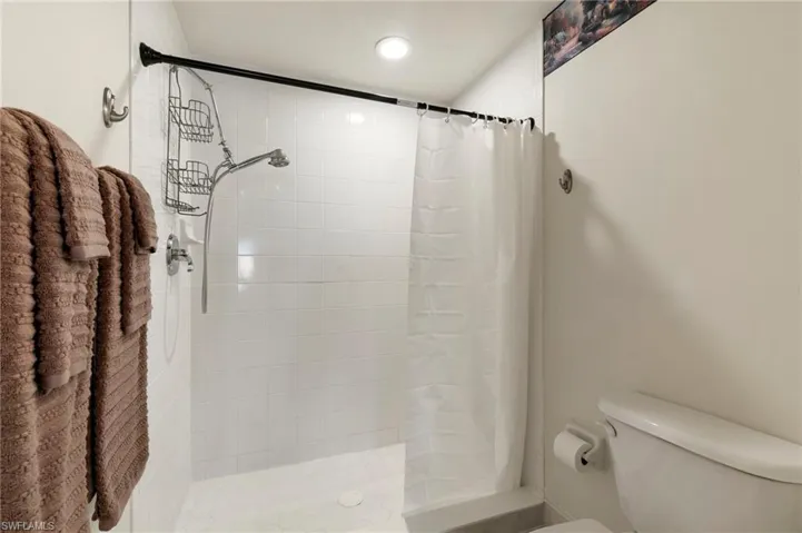 Bathroom with toilet and a tile shower