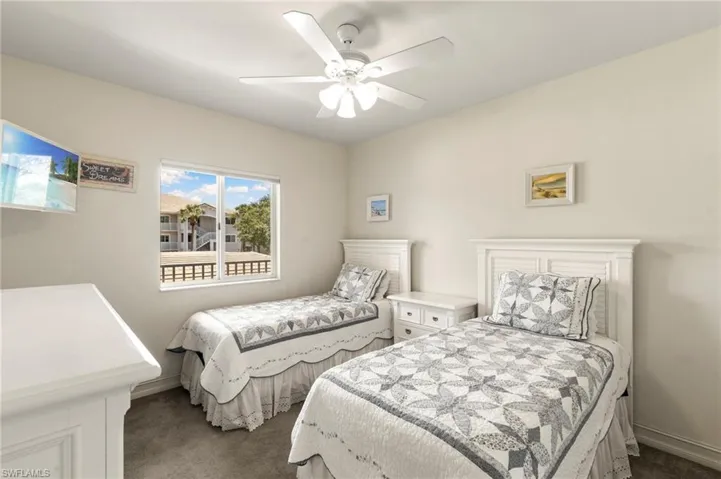 Bedroom featuring dark carpet, a ceiling fan, and baseboards