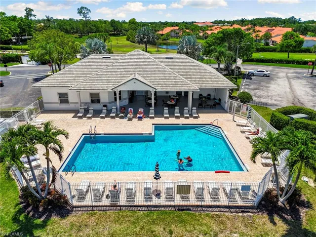 Community pool featuring fence and a patio