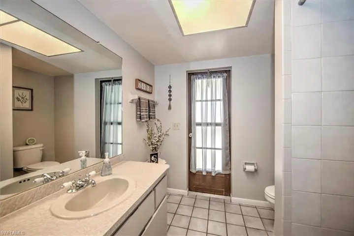Bathroom with tile patterned floors, vanity, and toilet