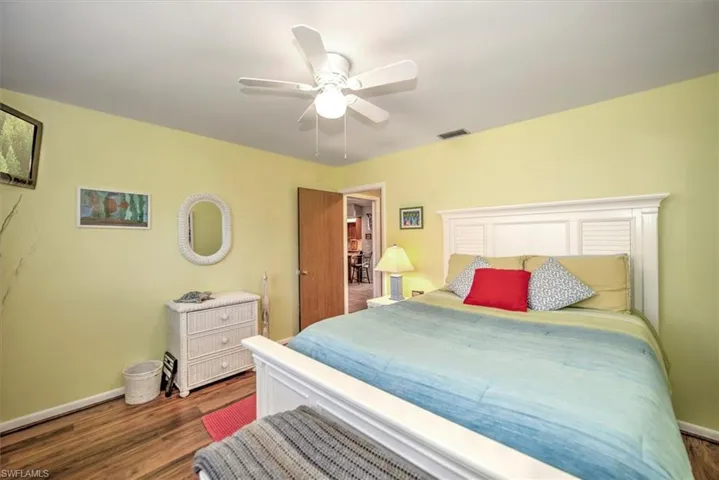 Bedroom with ceiling fan and dark hardwood / wood-style flooring