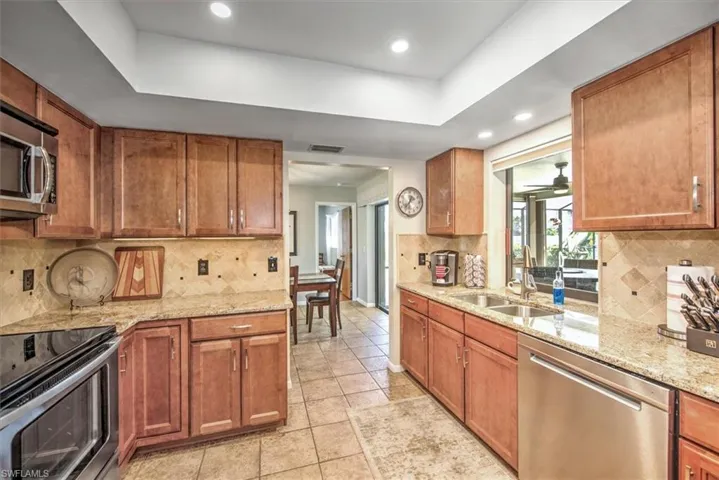 Kitchen with backsplash, sink, and stainless steel appliances