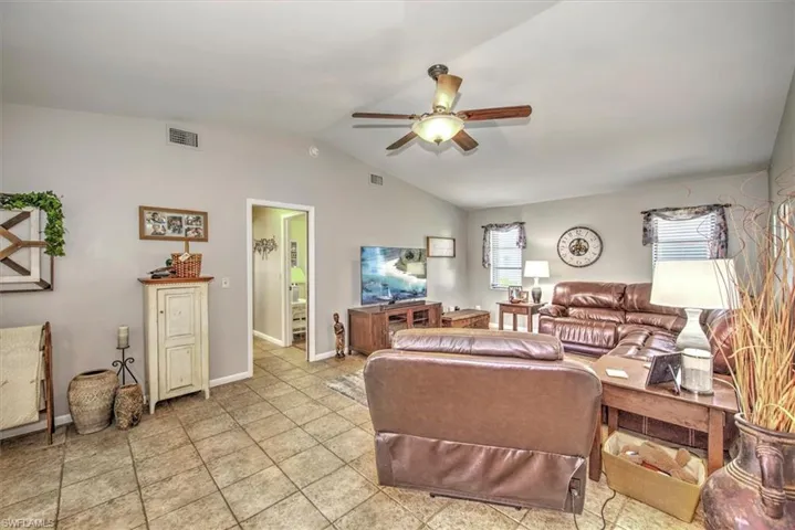 Living room with ceiling fan and vaulted ceiling
