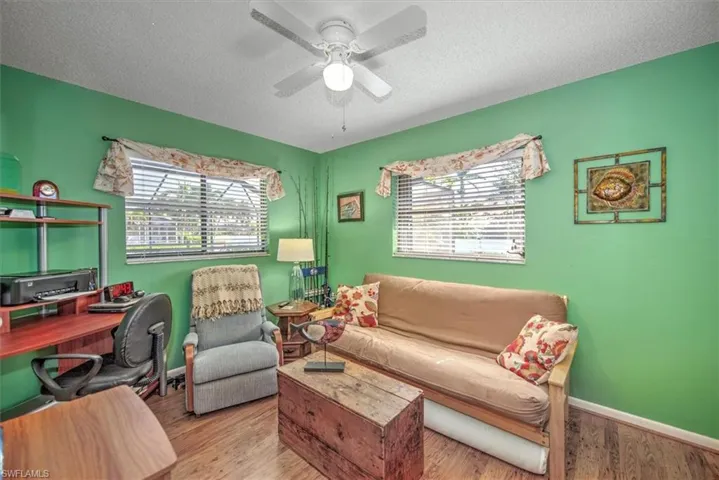 Office featuring a textured ceiling, light hardwood / wood-style floors, and plenty of natural light
