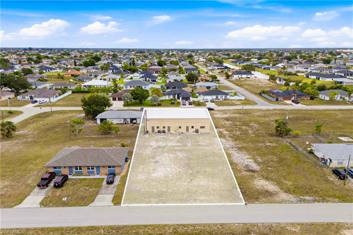 Prime commercial lot included in the sale, offering valuable space for future expansion, additional parking, storage, or redevelopment opportunities.