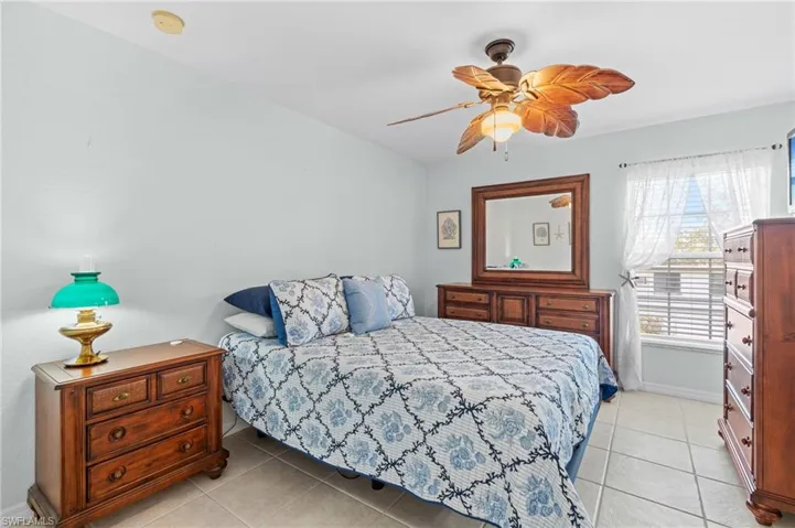 Bedroom featuring light tile patterned flooring and ceiling fan