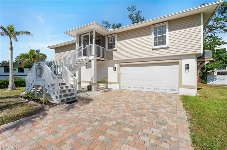 View of front of property with a garage and a front yard