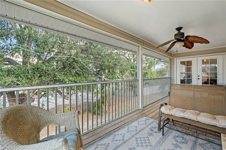 Sunroom with ceiling fan and a wealth of natural light