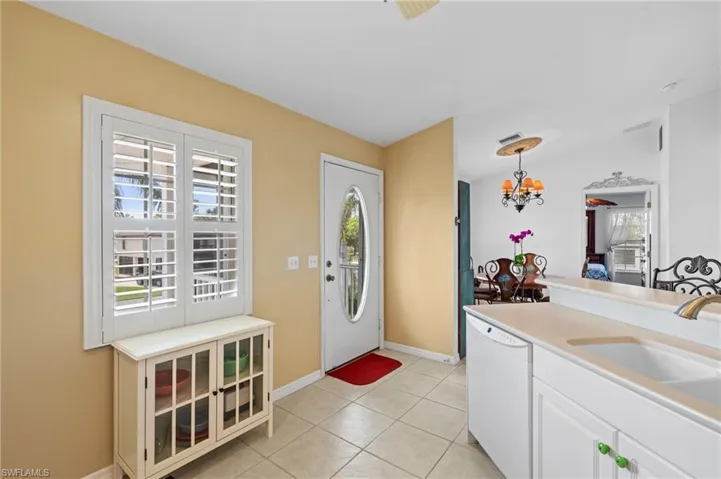 Entryway featuring an inviting chandelier, sink, and light tile patterned floors