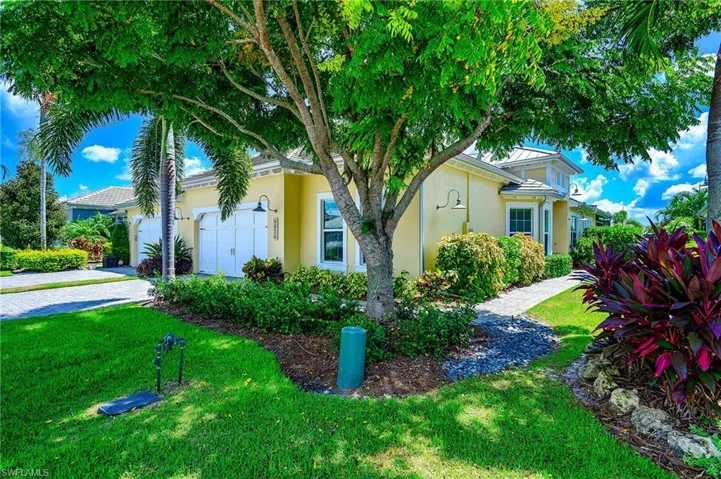 Obstructed view of property with a garage and a front yard