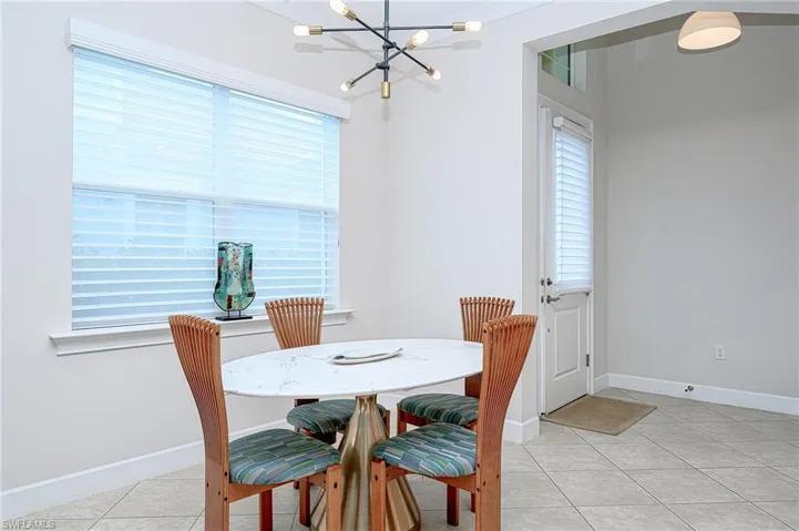 Tiled dining space with an inviting chandelier