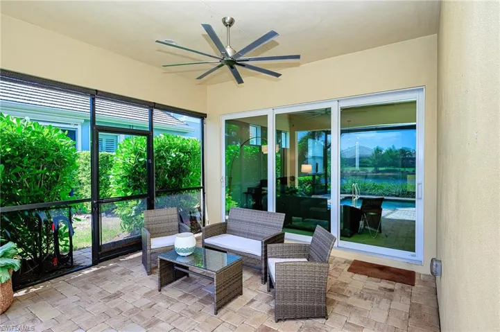 Sunroom with a healthy amount of sunlight and ceiling fan
