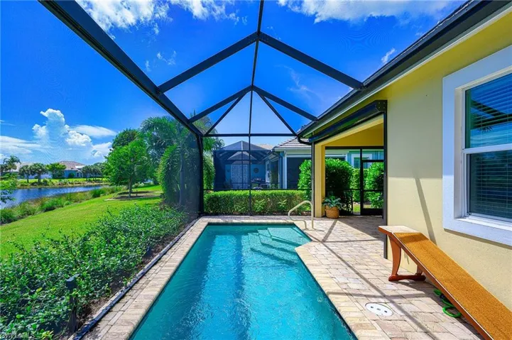 View of pool with a lanai and a patio area