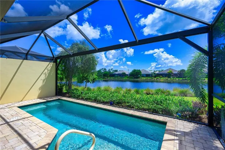 View of pool featuring a water view, a patio area, and a lanai