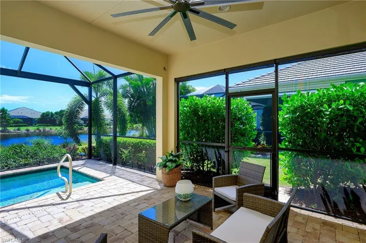 Sunroom featuring a water view and ceiling fan