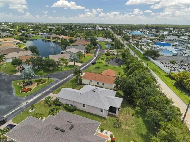 Aerial perspective showcasing the community layout with a central pond featuring a fountain