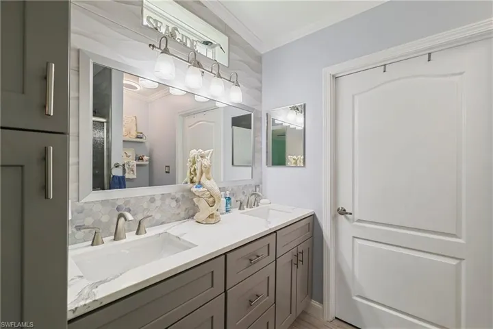 Dual vanity with white undermount sinks, white countertop, and brushed nickel hardware