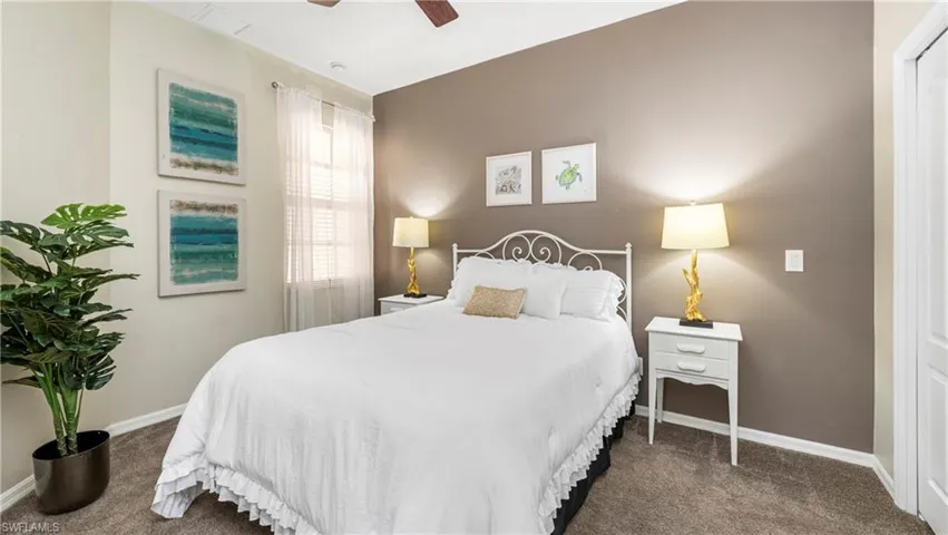 Bedroom with dark colored carpet and ceiling fan