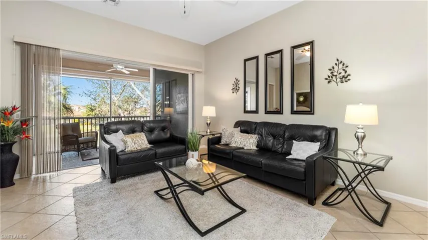 Living room featuring ceiling fan and light tile patterned flooring