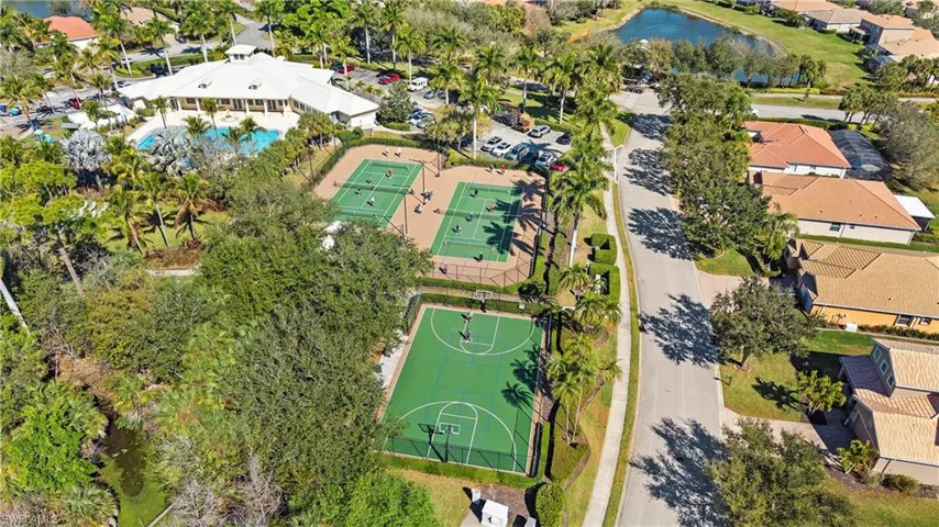 Aerial perspective of suburban area featuring a nearby body of water