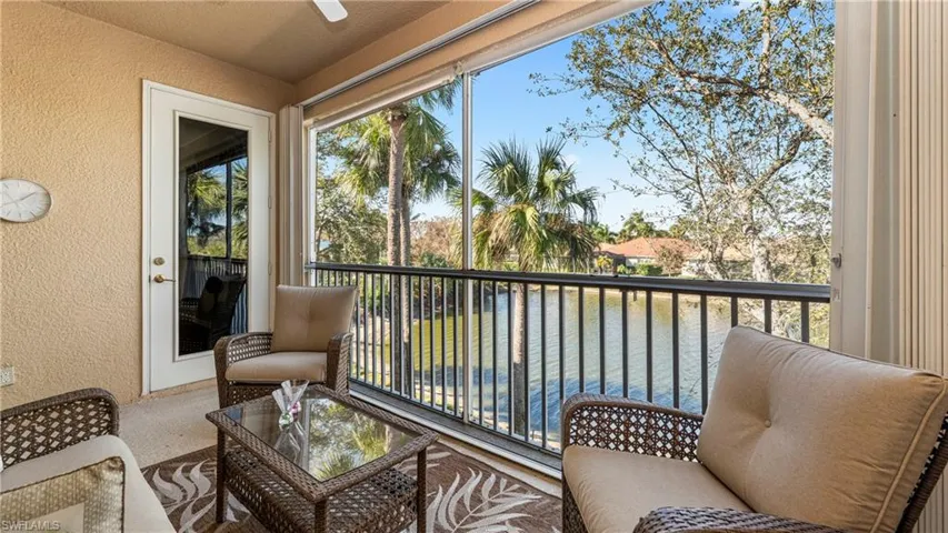 Sunroom featuring a balcony and a water view