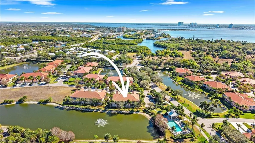 Aerial view of residential area featuring a nearby body of water