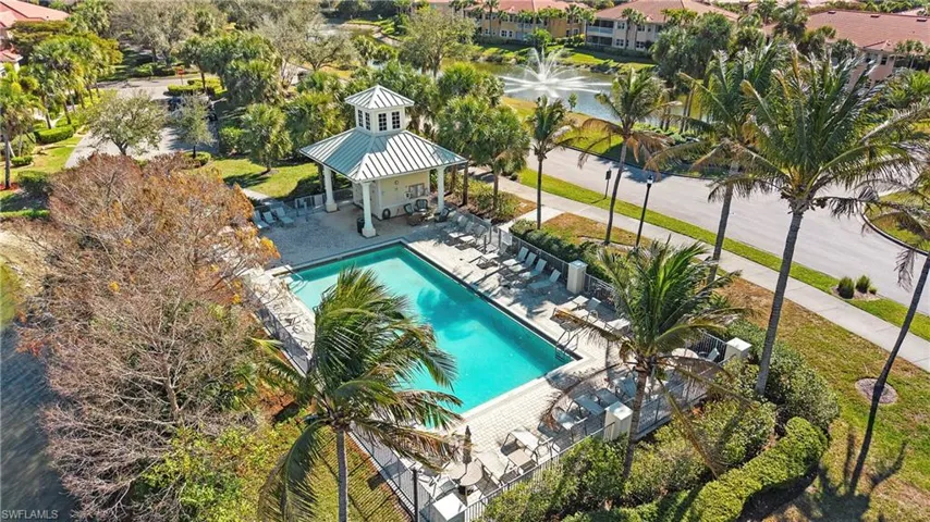 Community pool featuring a gazebo, a patio area, and a water view