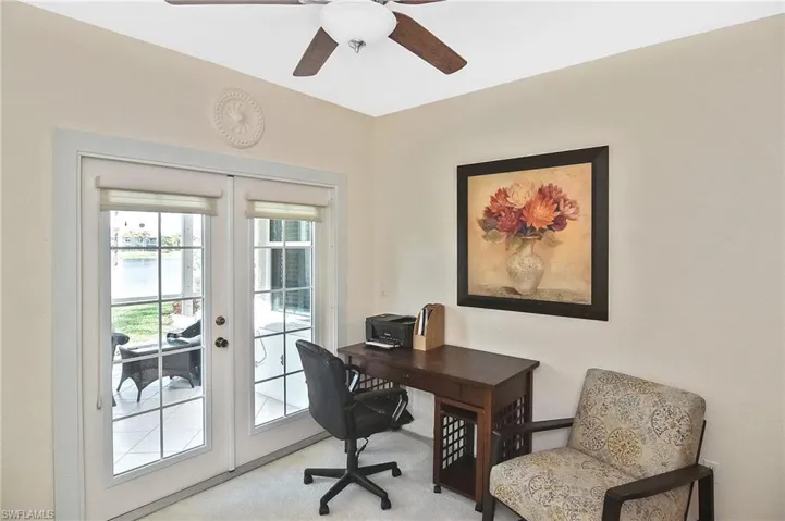 Office area featuring french doors, a ceiling fan, and light colored carpet