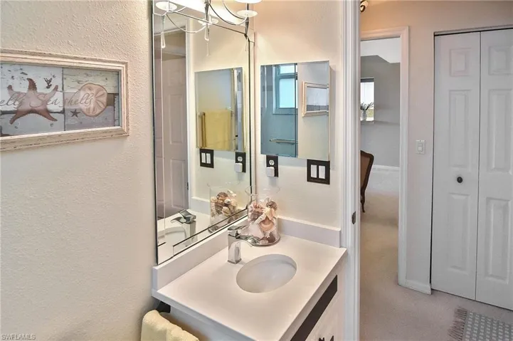 Bathroom with vanity and a textured wall