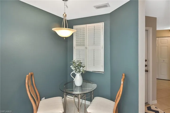 Tiled dining area with visible vents and baseboards