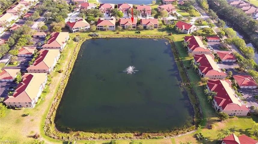 Birds eye view of property featuring a water view and a residential view