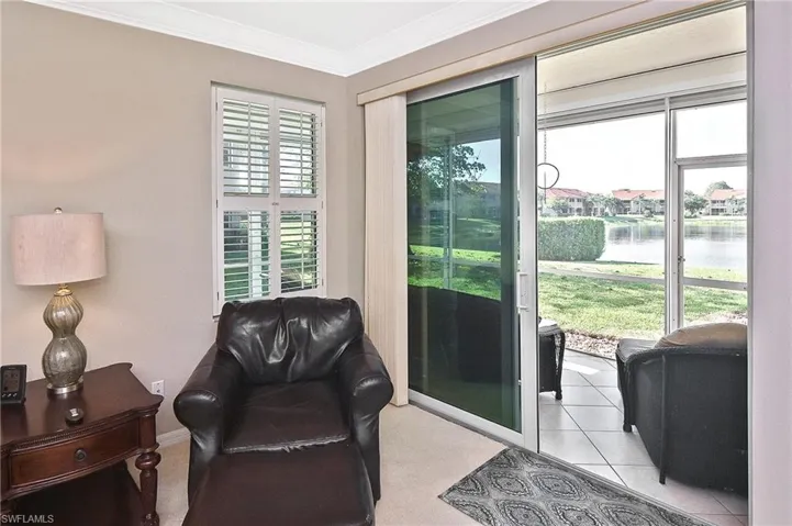 Entryway featuring crown molding and a water view