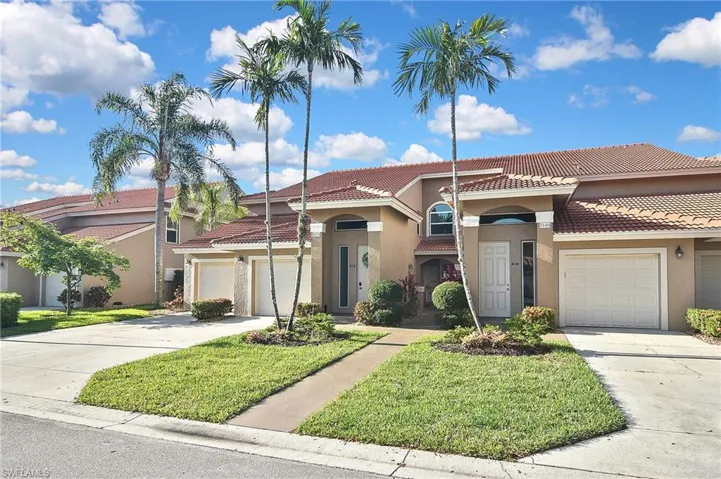 Mediterranean / spanish home featuring a front lawn, stucco siding, concrete driveway, and a tile roof