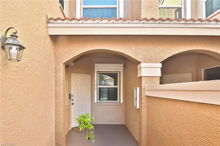Entrance to property featuring stucco siding