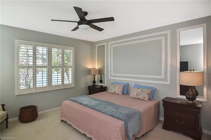 Bedroom with carpet flooring, a ceiling fan, and baseboards