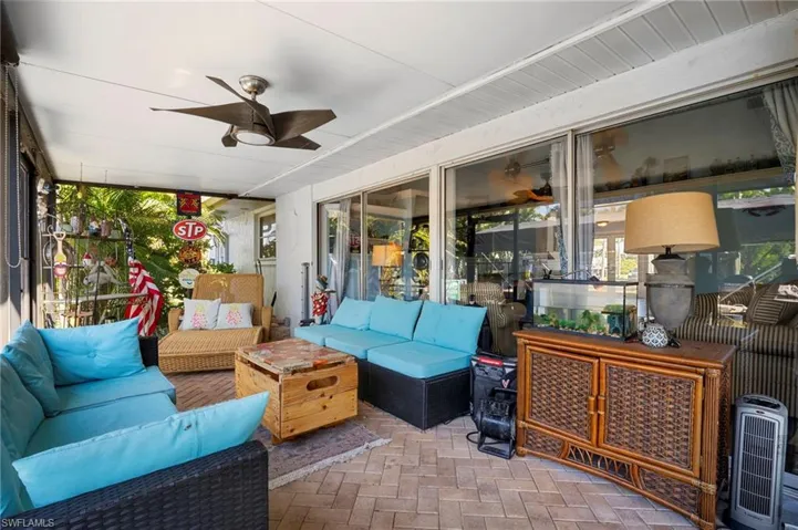 Sunroom / solarium with a ceiling fan, outdoor furniture, and a patio