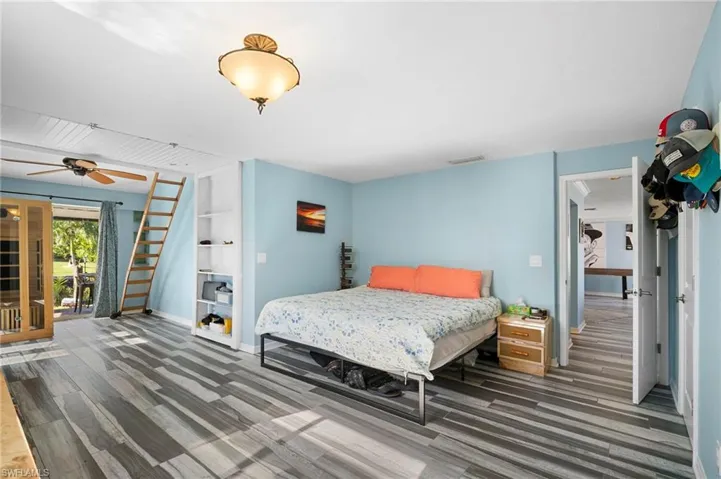 Bedroom featuring a sauna, access to exterior, and dark wood-type flooring