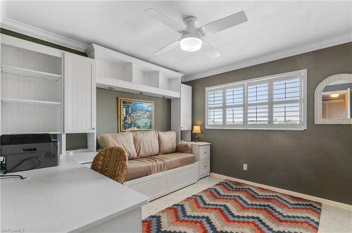 Guest room with built in office, extra storage, pull out bed, plantation shutters, crown molding, tile floors, newer light/fan.