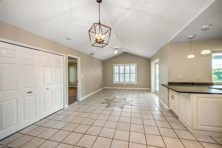Kitchen with plenty of natural light, pendant lighting, and light hardwood / wood-style flooring