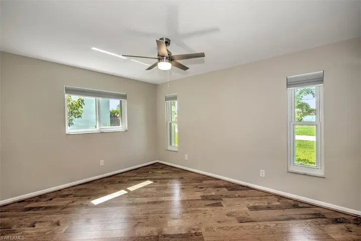 Spare room featuring ceiling fan and hardwood / wood-style floors