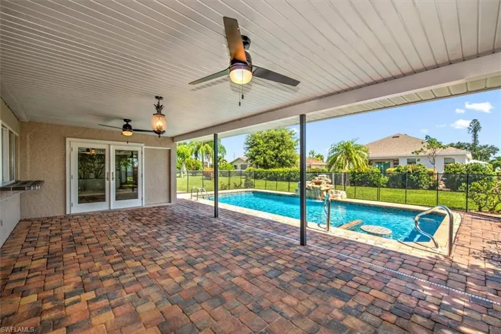 View of pool with ceiling fan and a patio area