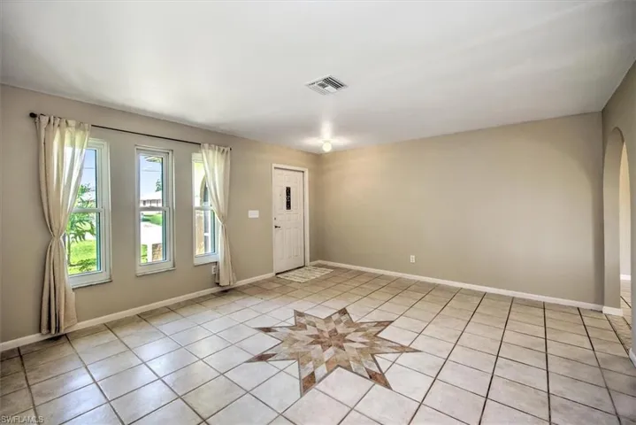 Unfurnished room with light tile patterned floors