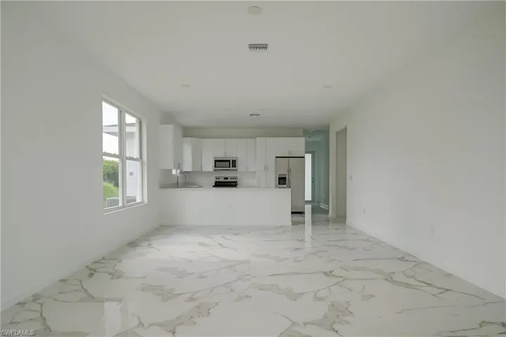 Unfurnished living room with sink