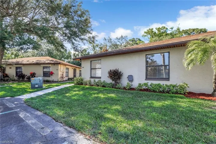 Single story home featuring stucco siding and a front yard