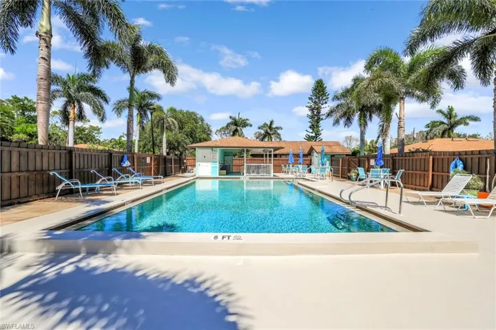 Community pool featuring fence and a patio area