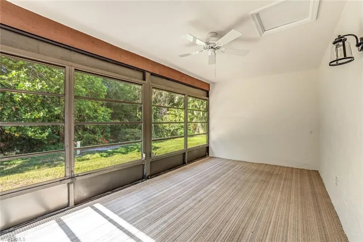 Unfurnished sunroom with a ceiling fan