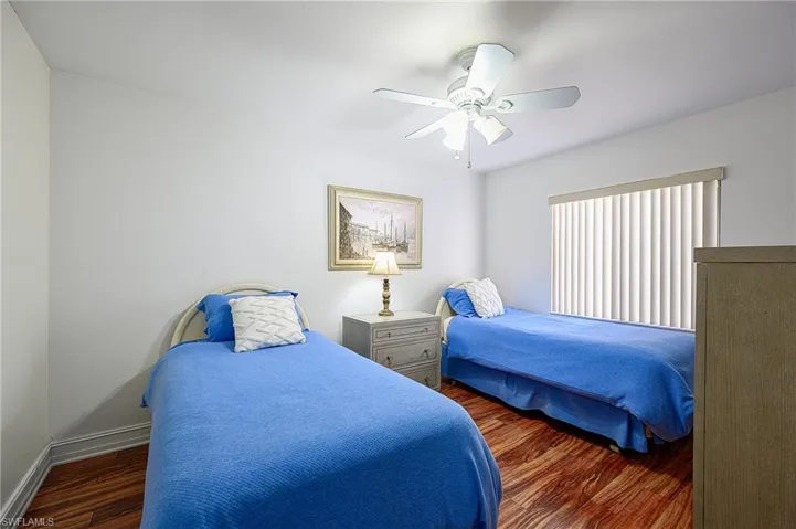 Bedroom featuring ceiling fan and dark hardwood / wood-style flooring